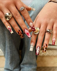 a woman's nails with different designs on them